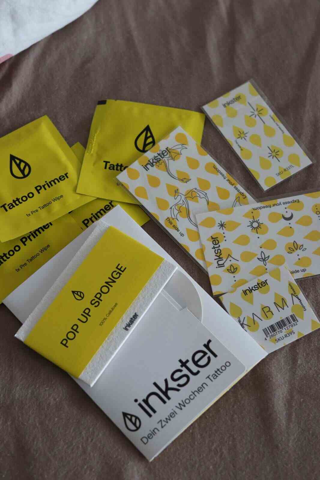 Inkster tattoo sheets, tattoo primer wipes and pop up sponge laid out before application